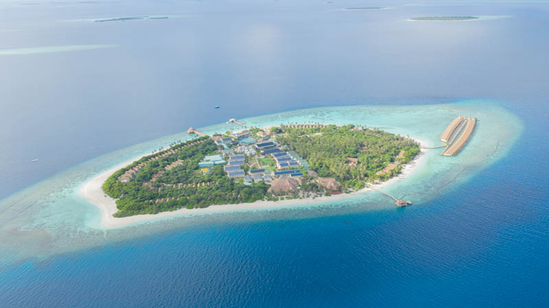Distand aerial of a large Swimsol rooftop PV system at an Reethi island resort in the Maldives