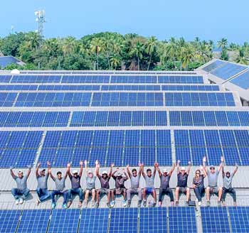 Swimsol staff a roof celebrating a completion of a large solar power installation