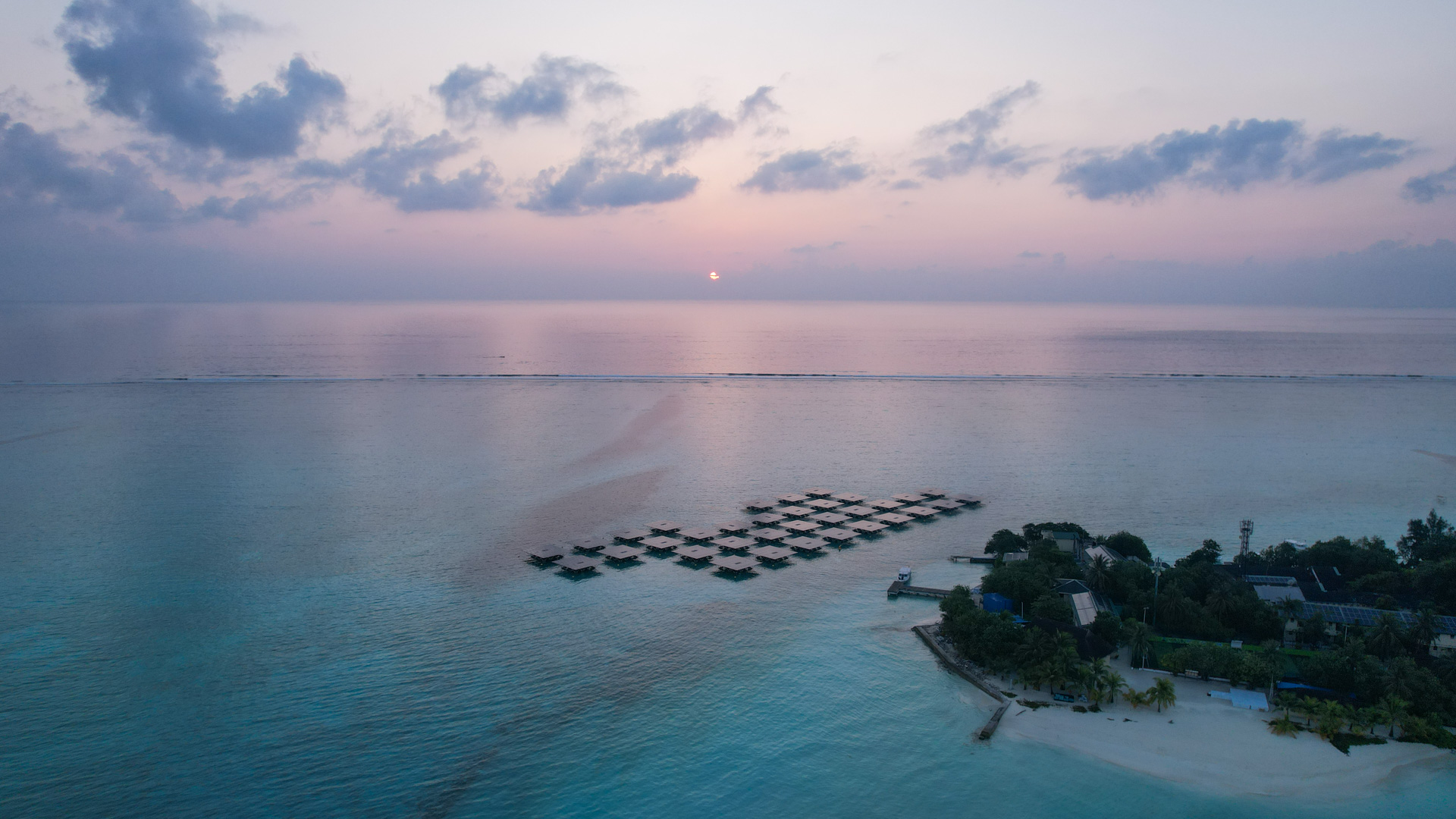 Aerial overview of a Swimsol SolarSea marine FPV installation at Taj Exotica Maldives, sunrise